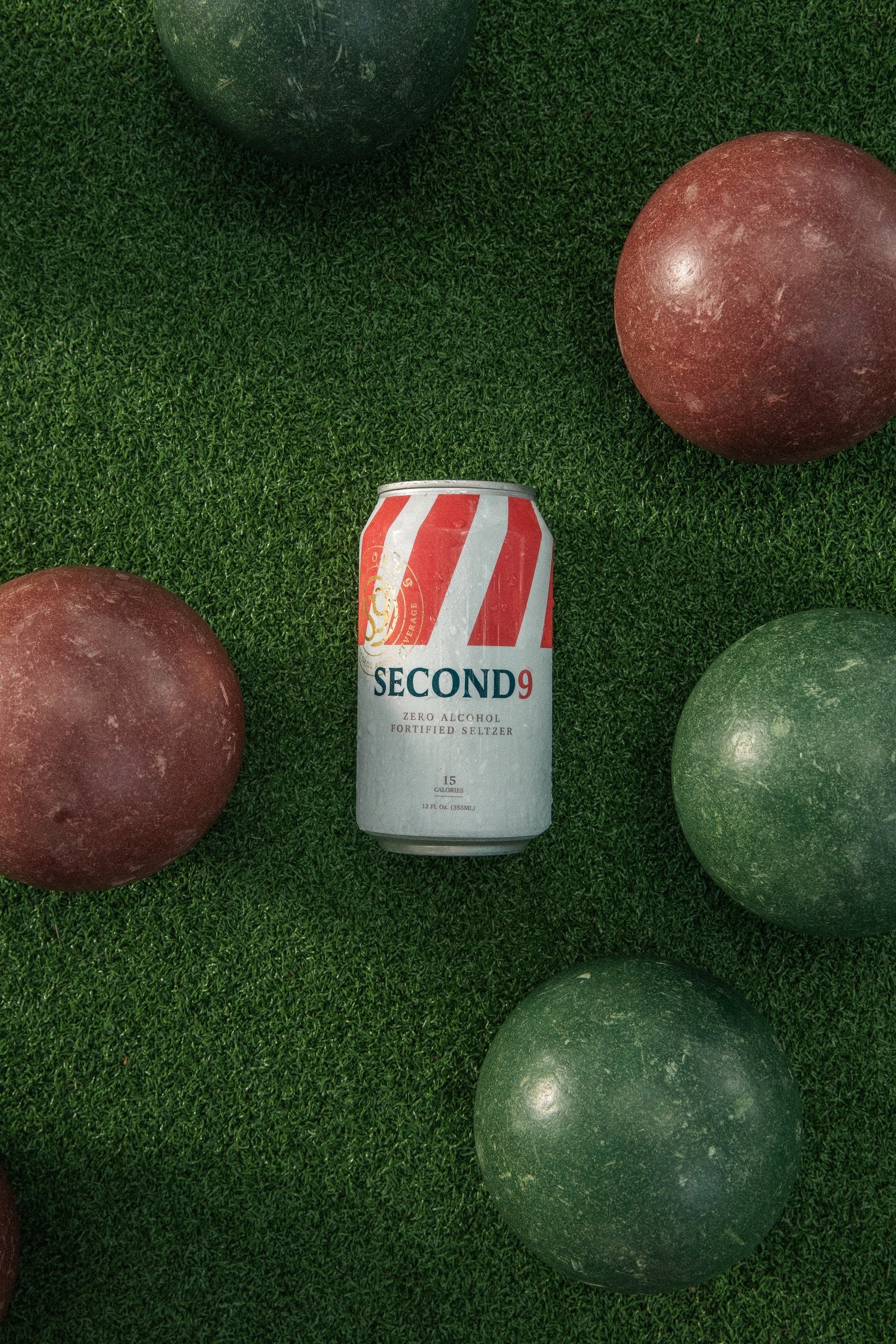 A Second9 can on the grass among bocce balls